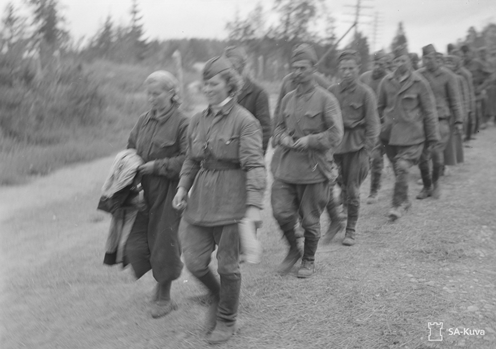 Ein finnisches PK-Foto von PK-Fotograf Manninen, aufgenommen in der Nähe von Sortavala im August 1941. Laut Bildunterschrift zeigt das Bild sowjetische Gefangene. Vorne sind zwei Soldatinnen zu erkennen, die nicht dem deutschen Feindbild von blutrünstigen „Flintenweibern“ entsprachen. Das Bild ist, vielleicht auch wegen der Unschärfe, von der Zensur als "nicht zu veröffentlichen" klassifiziert. Quelle: Finnish Wartime Photograph Archive (CC)