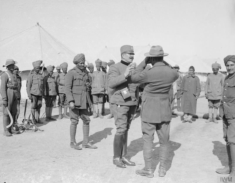 A Serbian Colonel showing an Indian Offcer how to use a Camera. Salonika, March 1917. © IWM Q 32816